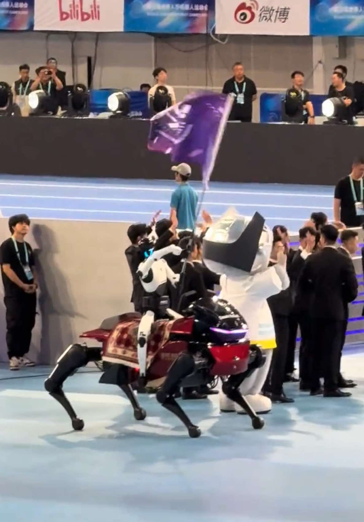Epic opening‑ceremony scene at World Humanoid Robot Games. Tiangong‑Ultra rides the DaxAI steed robot horse and waves th